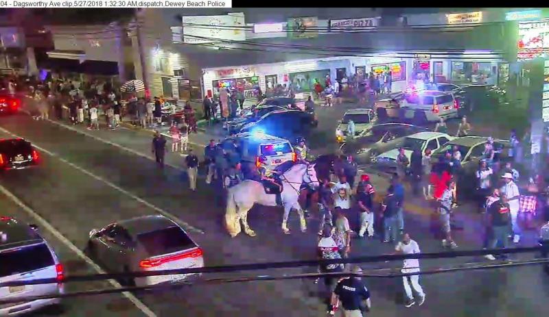 A federal civil trial over a 2018 incident in Dewey Beach where a man was accused of punching a police horse is set for May. This still image is from a video of the scene shows a large crowd gathered after fights broke out. The image was released by the Delaware Division of Alcohol and Tobacco Enforcement in 2018. FILE PHOTO